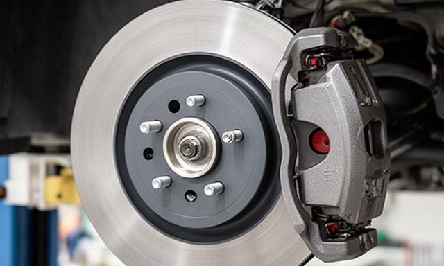 Close view of a clean brake disc and caliper during vehicle service